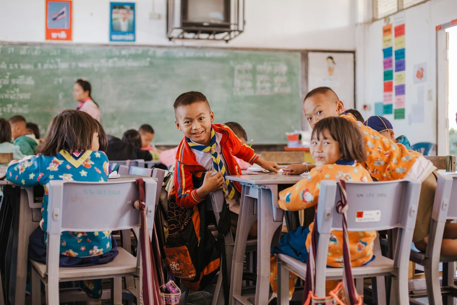 Children sitting at their desks in a busy classroom